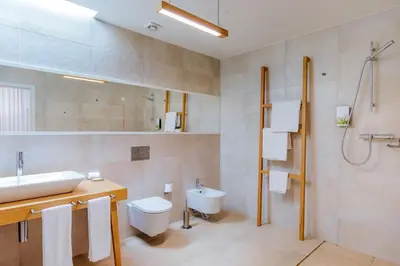 a bathroom with a sink and a toilet and a shower at Vila Baleira Village in Porto Santo