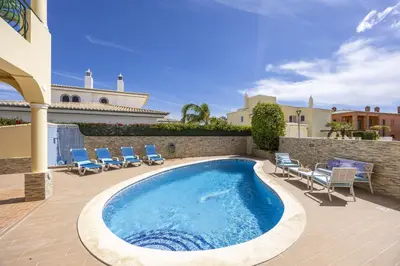 a villa with a swimming pool in front of a house at Sunflower Villa by Seewest in Lagos