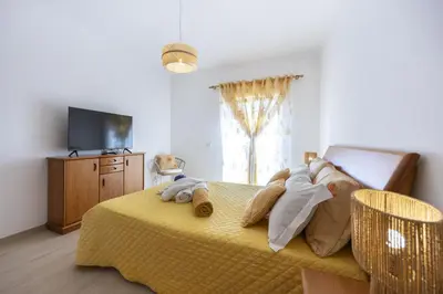 a bedroom with a large bed and a window at Sunflower Villa by Seewest in Lagos