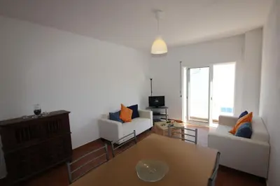 a living room with two white couches and a table at T3 Casa dos Arcos by Seewest in Salema