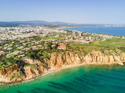 an aerial view of a city on a cliff over the ocean at T3 Casa dos Arcos by Seewest in Salema