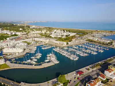 an aerial view of a harbor filled with boats at T3 Casa dos Arcos by Seewest in Salema