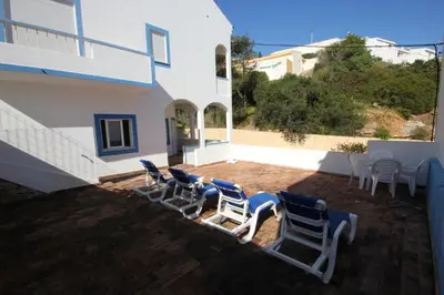 a group of chairs and tables on a patio at T3 Casa dos Arcos by Seewest in Salema