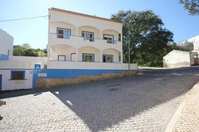 a building with a cobblestone street in front of it at T2 Casa dos Arcos by Seewest in Salema