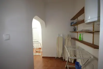 a kitchen with a table and an archway in a room at T2 Casa dos Arcos by Seewest in Salema