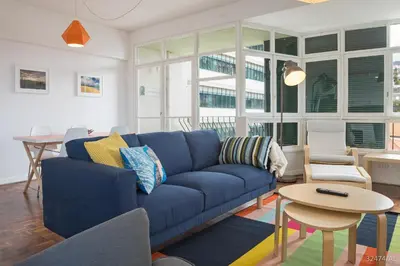 a living room with a blue couch and a table at Elias Garcia II by An Island Apart in Funchal