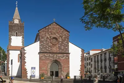 a church with a clock on the front of it at Elias Garcia II by An Island Apart in Funchal