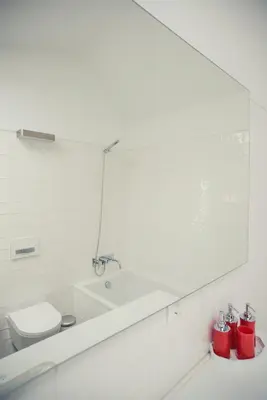 a bathroom with a sink and a toilet and a mirror at Vigia da Areia in São Lourenço