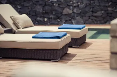 two beds with blue towels on them sitting on a floor at Vigia da Areia in São Lourenço