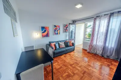 a living room with a couch and a table at Apartamento Vista Oceano in Caniço