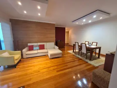 a living room with a couch and a table at Cozy and Bright Apartment in Machico