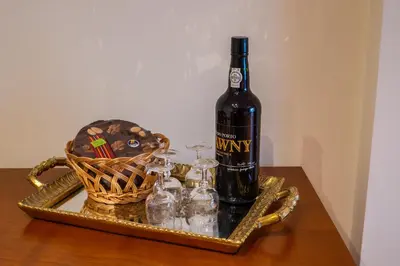 a bottle of wine and a basket on a table at Cozy and Bright Apartment in Machico