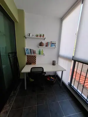 a desk with a chair in a room with a window at Cozy and Bright Apartment in Machico