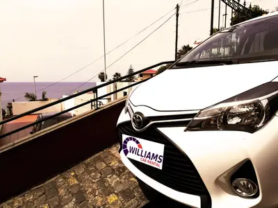 a white car with a sticker on the front at Cozy and Bright Apartment in Machico