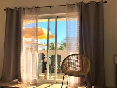 a room with a window with a view of a patio at Casas da Vila in Luz