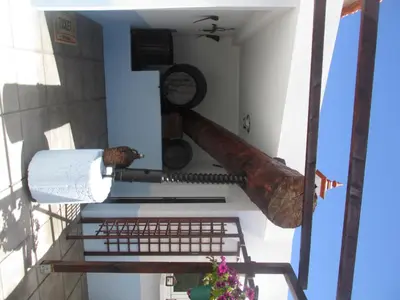 a cannon on the side of a building at Casa Formiga in Fajã da Ovelha