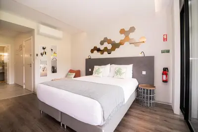 a bedroom with a large white bed in a room at Casa do Manuel in Santana