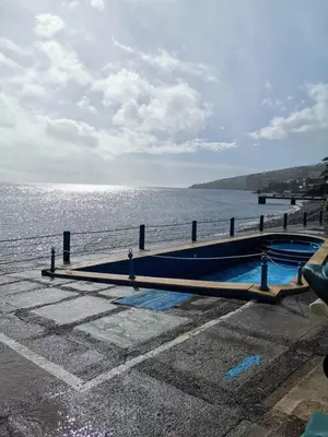 a large body of water with a pier and a boat at Morena house in Santa Cruz