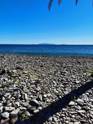 a large group of rocks on a beach with the ocean at Morena house in Santa Cruz