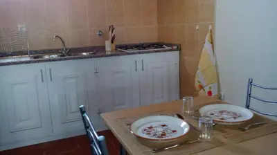 a kitchen with two plates on a table at Morena house in Santa Cruz