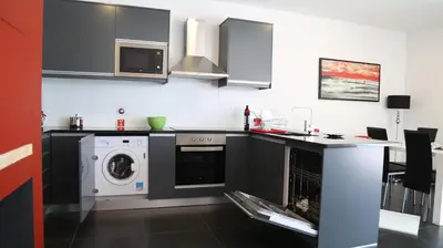 a kitchen with a washer and dryer in it at A&M House in Arco da Calheta