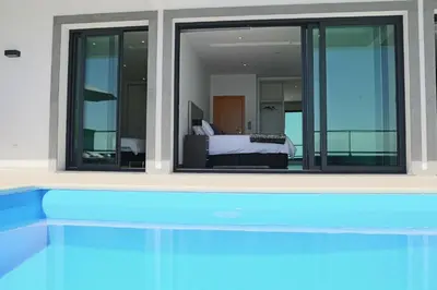 a view of a bedroom from a swimming pool at A&M House in Arco da Calheta