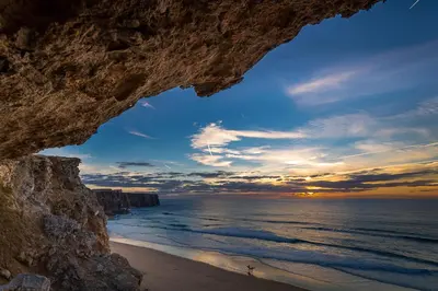 a view of the ocean from a cave on a beach at Mareta Beach House - Boutique Residence in Sagres
