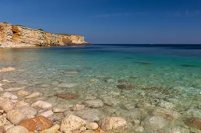 a beach with rocks and the clear water at Mareta Beach House - Boutique Residence in Sagres
