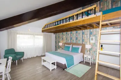 a bedroom with a bunk bed with a ladder at Mareta Beach House - Boutique Residence in Sagres