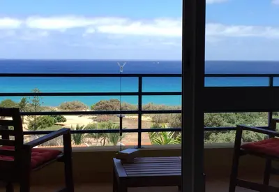 a room with a view of the ocean from a balcony at Apartamento Bela Vista in Porto Santo