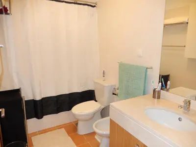 a bathroom with a white toilet and a sink at Apartamento Bela Vista in Porto Santo