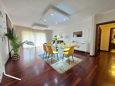 a dining room and living room with a table and chairs at Colinas do Lido III by Rentallido in Funchal