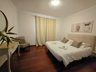 a bedroom with a bed and a desk in it at Colinas do Lido III by Rentallido in Funchal