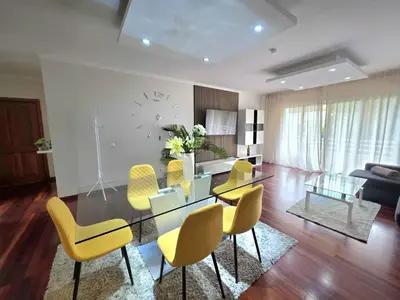 a living room with a dining table and yellow chairs at Colinas do Lido III by Rentallido in Funchal