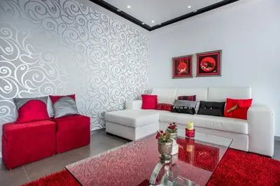 a living room with a white couch and red furniture at Villa São Lourenço in Fajã da Ovelha