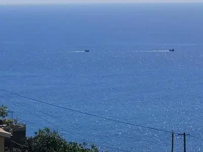 a view of the ocean with two boats in the water at Villa Formosa in Funchal