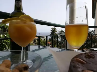 a glass of wine and a glass of food on a table at Villa Formosa in Funchal