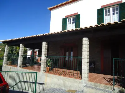 a house with a gate in front of it at Casa da Rainha in Calheta