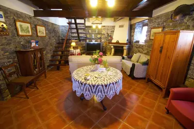 a living room with a table with flowers on it at Casa da Rainha in Calheta