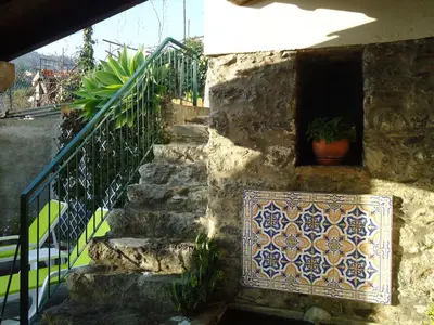 a set of stairs with a mosaic tile on the wall at Casa da Rainha in Calheta