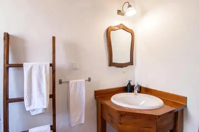 a bathroom with a sink and a mirror at Carrapateiramar Guest House in Carrapateira