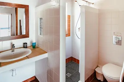 a bathroom with a sink and a toilet at Carrapateiramar Guest House in Carrapateira