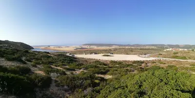 a view of the beach from the top of a hill at Carrapateiramar Guest House in Carrapateira