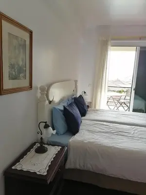 a bedroom with a bed and a window at Ladeira Centro in Funchal