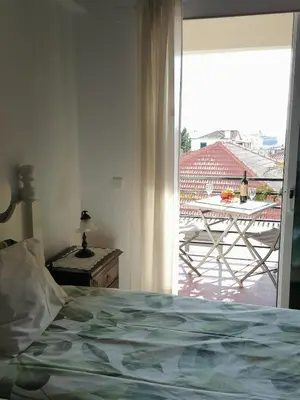 a bedroom with a bed and a view of a patio at Ladeira Centro in Funchal