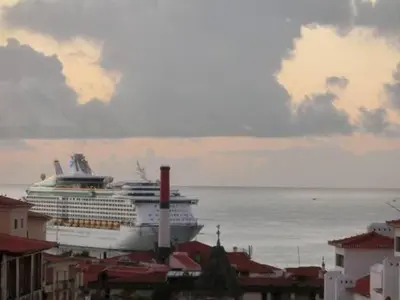 a cruise ship in the ocean next to a city at Ladeira Centro in Funchal