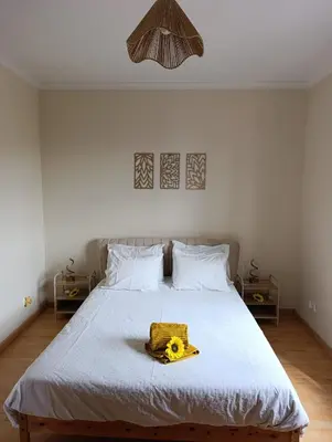 a bedroom with a bed with a yellow object on it at Maison Zita in Venda do Atalhinho