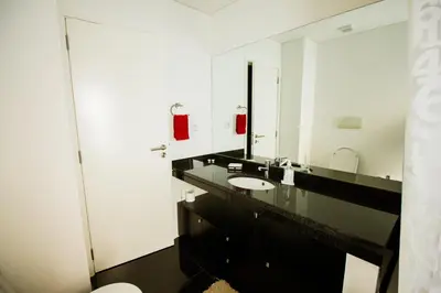 a bathroom with a sink and a large mirror at Quinta da Nogueira in Funchal