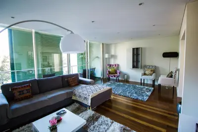 a living room with a couch and a table at Quinta da Nogueira in Funchal