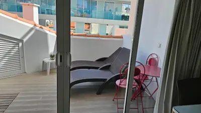 a balcony with a couch and chairs on a balcony at Canavial Terrace@Heart of Funchal in Funchal